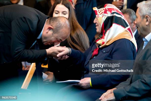 Mevlut Cavusoglu, Foreign Minister of Turkey, kisses the hand of Mevlude Genc during the commemoration of the arson attack on the house of the...