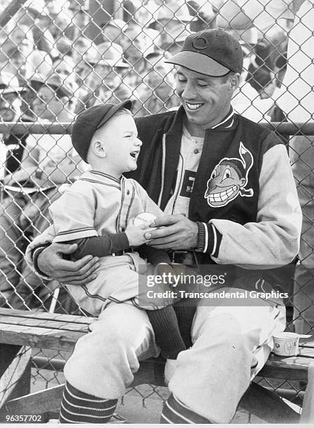 Bob Feller and a young Indians fan share a laugh before a game at Municipal Stadium in Cleveland in 1948.