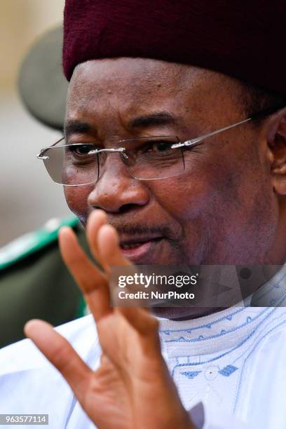 Niger's President Mahamadou Issoufou waves as he arrives for an international conference on Libya at the Elysee Presidential Palace on May 29 in...