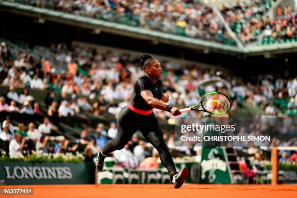 Serena Williams of the US plays a forehand return to Czech Republic's Kristyna Pliskova during their women's singles first round match on day three...