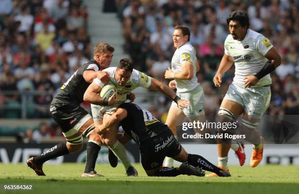 Brad Barritt of Saracens is tackled during the Aviva Premiership Final between Exeter Chiefs and Saracens at Twickenham Stadium on May 26, 2018 in...