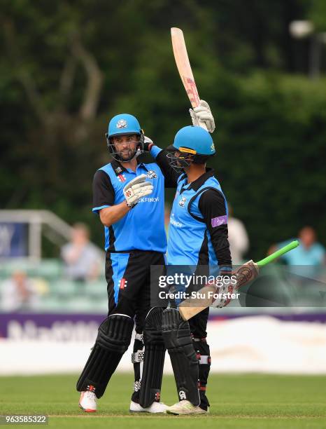 Royals batsman Callum Ferguson celebrates his 150 with Brett D'Oliveira during the Royal London One Day Cup match between Worcestershire and...