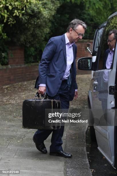 Reported lawyer leaves a building as musician Jimmy Page leaves his home to go to Kensington Town hall for his planning permission dispute case...