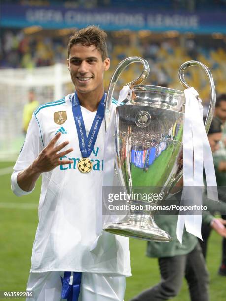 Raphael Varane of Real Madrid celebrates with the trophy after the UEFA Champions League Final between Real Madrid and Liverpool at NSC Olimpiyskiy...