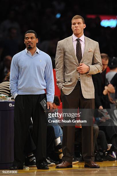 Athletic trainer Jasen Powell and Blake Griffin of the Los Angeles Clippers look on from the sideline during the game against the Los Angeles Lakers...