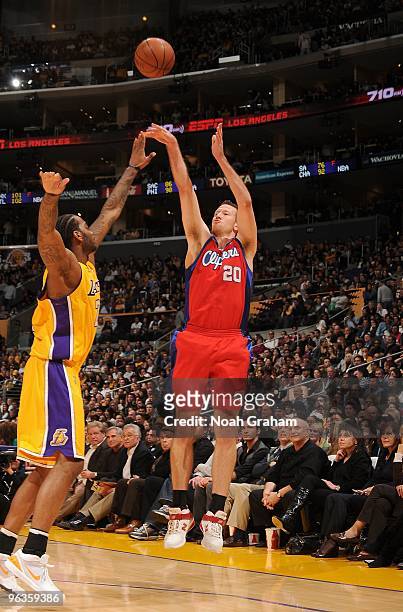 Steve Novak of the Los Angeles Clippers takes a jump shot against Josh Powell of the Los Angeles Lakers during the game at Staples Center on January...