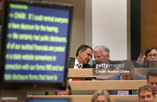 Dr. Kumble R. Subbaswamy, left, chancellor of UMass Amherst, talks with UMass President Marty Meehan as a screen on the left electronically...