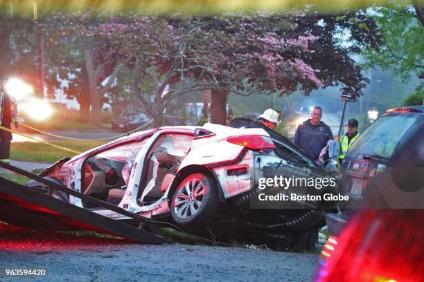 Tow truck removes the wreckage from a fatal single car crash in East Bridgewater, MA on May 19, 2018. Four male teenagers were killed and a fifth was...