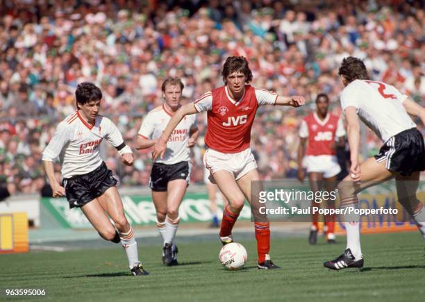Alan Hansen of Liverpool closes down Niall Quinn of Arsenal during the Littlewoods League Cup Final at Wembley Stadium on April 5, 1987 in London,...