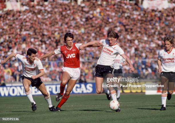 David O'Leary of Arsenal is out-numbered by Nigel Spackman and Ian Rush of Liverpool during the Littlewoods League Cup Final at Wembley Stadium on...