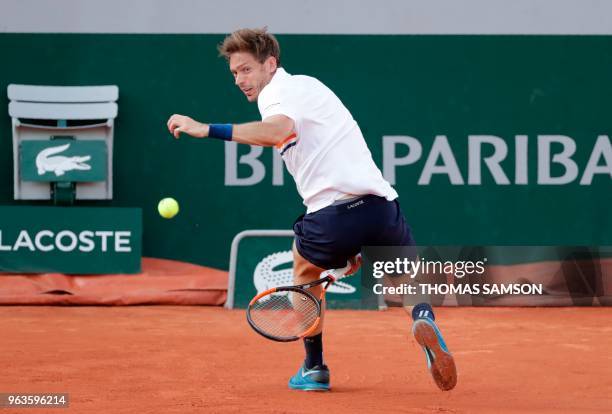 France's Nicolas Mahut plays a return to Argentina's Juan Martin del Potro during their men's singles first round match on day three of The Roland...