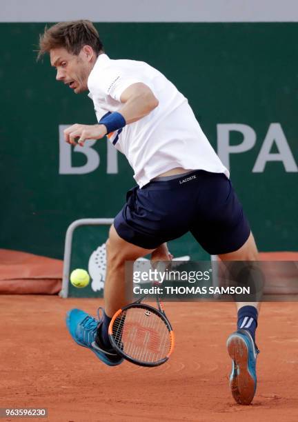 France's Nicolas Mahut plays a return to Argentina's Juan Martin del Potro during their men's singles first round match on day three of The Roland...