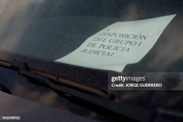 Sign reads "At the disposal of group I of judicial police" on a car seized from drug cartels in a parking lot in San Roque near Algeciras on May 29,...