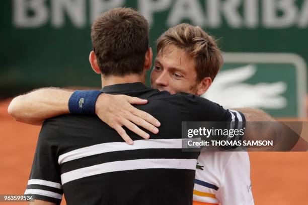 Argentina's Juan Martin del Potro is congratulated by France's Nicolas Mahut after winning their men's singles first round match on day three of The...