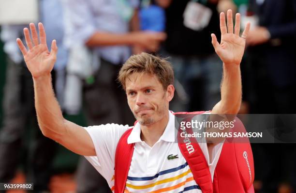 France's Nicolas Mahut waves to supporters after losing his men's singles first round match against Argentina's Juan Martin del Potro on day three of...