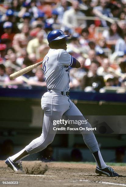 S: Outfielder Dusty Baker of the Los Angeles Dodgers swings and watches the flight of his ball against the New York Mets during a late circa 1970's...