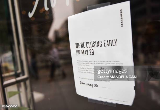 Store closed" note is displayed at a Starbucks store on May 29, 2018in Washington, DC. - Starbucks is closing more than 8,000 stores across the...