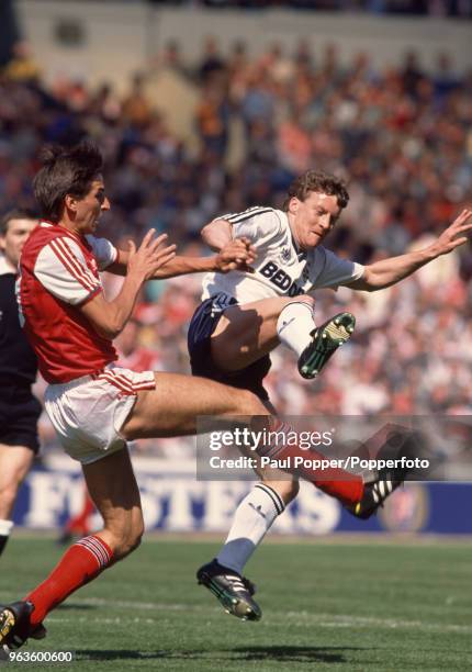 Alan Smith of Arsenal and Danny Wilson of Luton Town collide during the Littlewoods League Cup Final at Wembley Stadium on April 24, 1988 in London,...