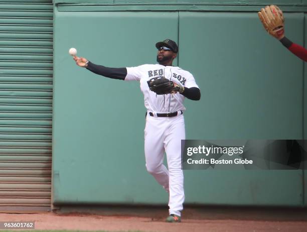 Boston Red Sox player Jackie Bradley Jr. Throws the ball back into the infield after robbing Toronto Blue Jays' Kendrys Morales of an extra base hit...