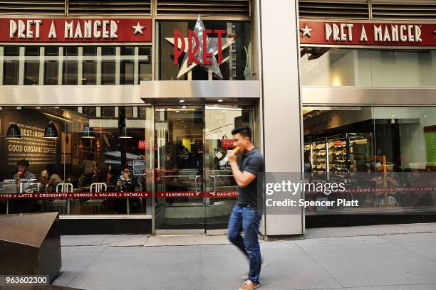 People walk by a Pret A Manger food chain in lower Manhattan on May 29, 2018 in New York City. The Luxembourg-based holding company JAB said on...