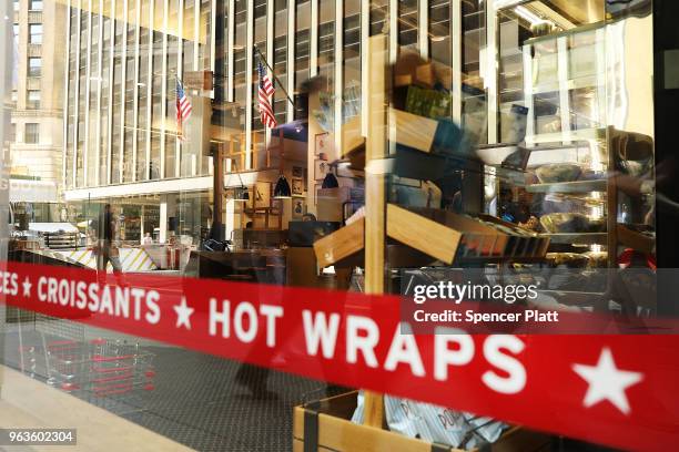 People walk by a Pret A Manger food chain in lower Manhattan on May 29, 2018 in New York City. The Luxembourg-based holding company JAB said on...