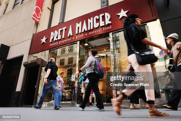 People walk by a Pret A Manger food chain in lower Manhattan on May 29, 2018 in New York City. The Luxembourg-based holding company JAB said on...