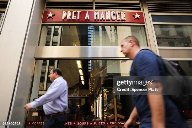 People walk by a Pret A Manger food chain in lower Manhattan on May 29, 2018 in New York City. The Luxembourg-based holding company JAB said on...