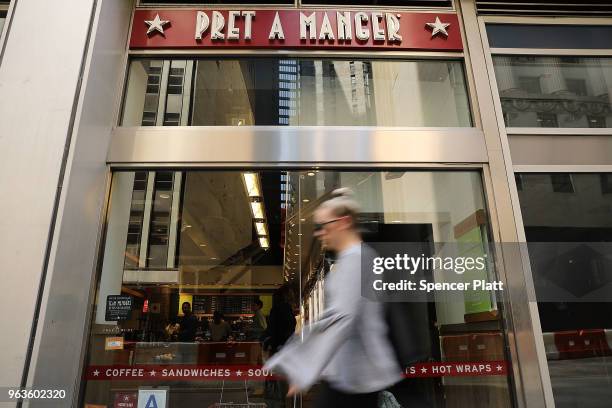 People walk by a Pret A Manger food chain in lower Manhattan on May 29, 2018 in New York City. The Luxembourg-based holding company JAB said on...