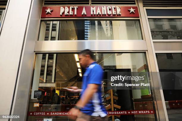 People walk by a Pret A Manger food chain in lower Manhattan on May 29, 2018 in New York City. The Luxembourg-based holding company JAB said on...