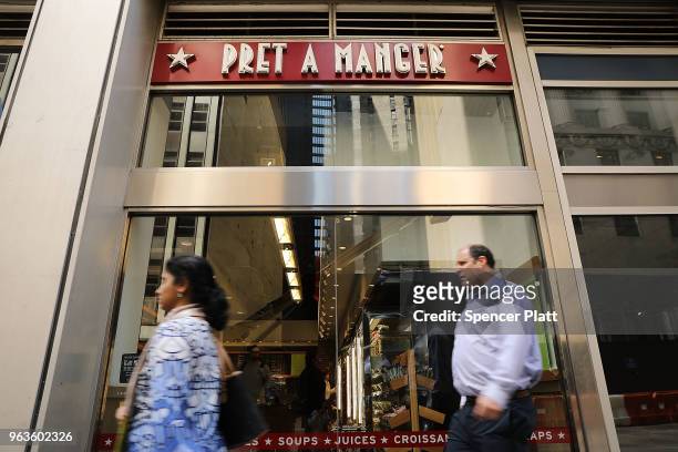 People walk by a Pret A Manger food chain in lower Manhattan on May 29, 2018 in New York City. The Luxembourg-based holding company JAB said on...