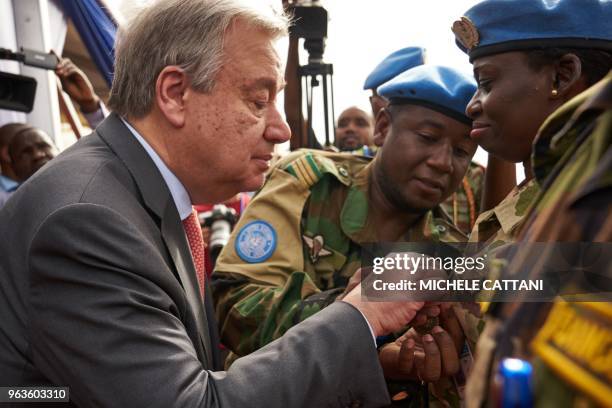 United Nations Secretary General Antonio Guterres gives a medal to a UN soldier during the ceremony of Peacekeepers' Day at the operating base of...