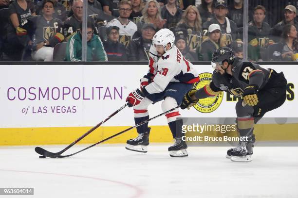 Chandler Stephenson of the Washington Capitals battles for the puck with Luca Sbisa of the Vegas Golden Knights in Game One of the 2018 NHL Stanley...