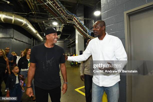 Dell Curry and Hakeem Olajuwon before Game Seven of the Western Conference Finals between the Golden State Warriors and the Houston Rockets during...