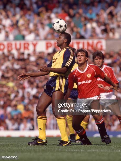 David Rocastle of Arsenal is watched by Clayton Blackmore of Manchester United during a Barclays League Division One match at Old Trafford on August...