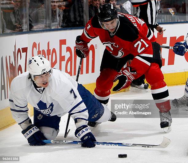 Garnet Exelby of the Toronto Maple Leafs gets tripped by Rob Niedermayer of the New Jersey Devils during game action February 2, 2010 at the Air...