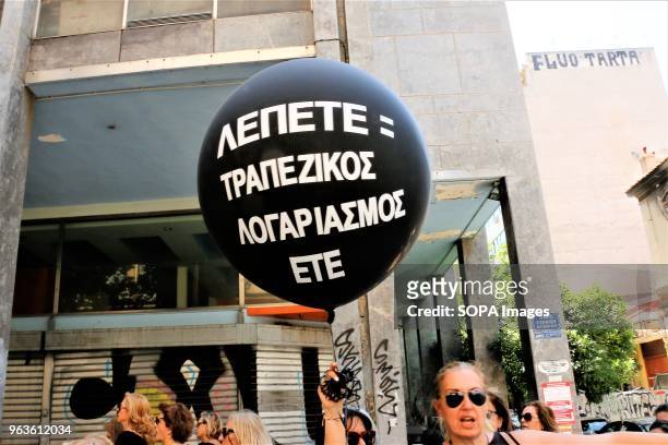 Woman seen holding a air balloon with slogans written on it during the demonstration. Greek pensioners of the National Bank of Greece demonstrate in...