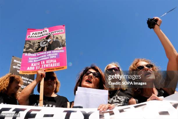 Women seen holding a large banner during the demonstration. Greek pensioners of the National Bank of Greece demonstrate in Athens demanding a stop to...