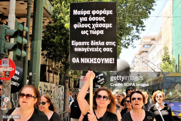 Woman seen holding a placard during the demonstration. Greek pensioners of the National Bank of Greece demonstrate in Athens demanding a stop to the...