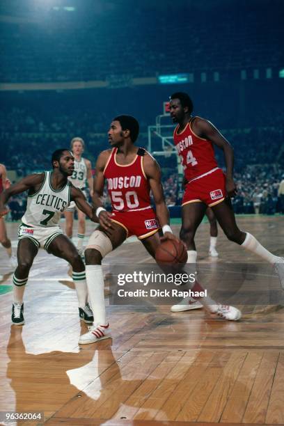 Robert Reid of the Houston Rockets drives the ball up court against Nate Archibald of the Boston Celtics during a game played in 1981 at the Boston...