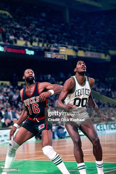 Robert Parish of the Boston Celtics looks to rebound against Bob Lanier of the Milwakuee Bucks during a game played in 1981 at the Boston Garden in...