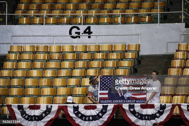 Supporters hold a flag featuring President Trump before the start of a rally with U.S. President Donald Trump at the Nashville Municipal Auditorium,...