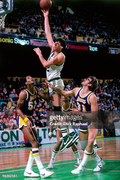 Kevin McHale of the Boston Celtics puts up a shot against Jamaal Wilkes and Kurt Rambis of the Los Angeles Lakers during a game played in 1981 at the...