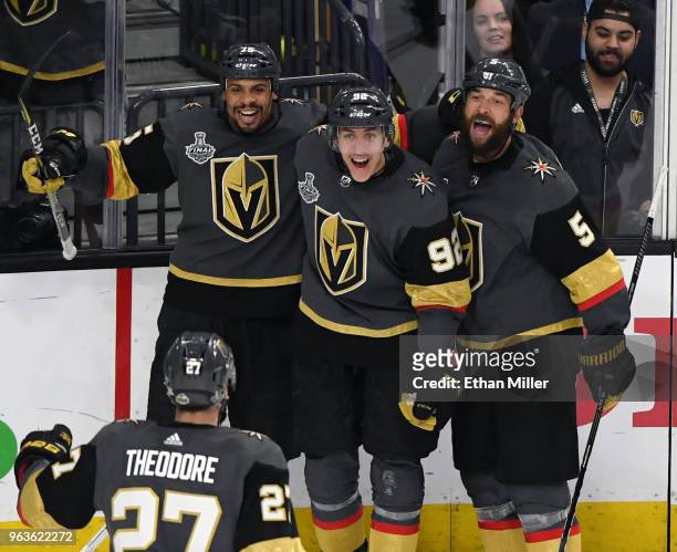 Shea Theodore of the Vegas Golden Knights skates over to celebrate with teammates Ryan Reaves, Tomas Nosek and Deryk Engelland after Theodore...