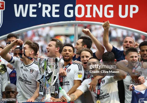 Kevin McDonald of Fulham and Tom Cairney of Fulham lift the trophy following their sides victory in the Sky Bet Championship Play Off Final between...