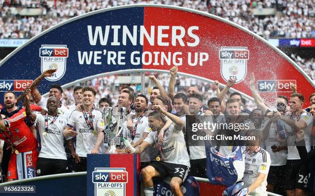 Kevin McDonald of Fulham and Tom Cairney of Fulham lift the trophy following their sides victory in the Sky Bet Championship Play Off Final between...