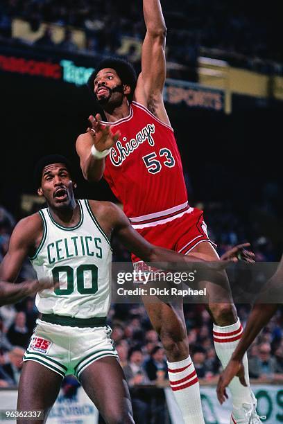 Artis Gilmore of the Chicago Bulls goes up for a shot against Robert Parish of the Boston Celtics during a game played in 1981 at the Boston Garden...