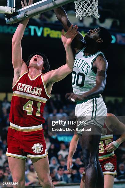 Bill Laimbeer of the Cleveland Cavaliers shoots against Robert Parish of the Boston Celctis during a game played in 1981 at the Boston Garden in...