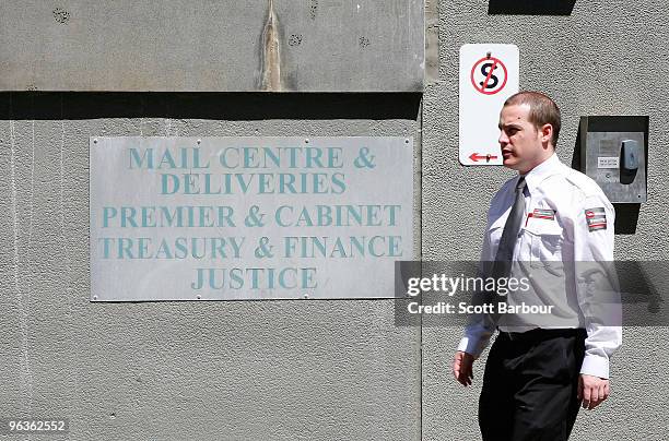 Security guard patrols the area after a suspect package containing an unidentified powder was found in the mail room of the Victorian Premier's...