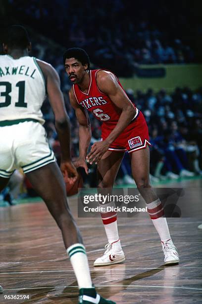 Julius Erving of the Philadelphia 76ers looks to make a move aganist Cedric Maxwell of the Boston Celtics during a game played in 1981 at the Boston...