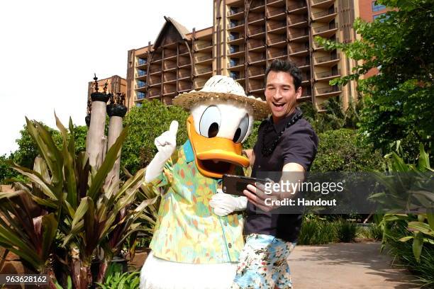 In this handout photo provided by Disney Parks, Actor Jay Hayden meets Donald Duck at Aulani, a Disney Resort & Spa on May 25, 2018 Ko Olina, Hawaii.